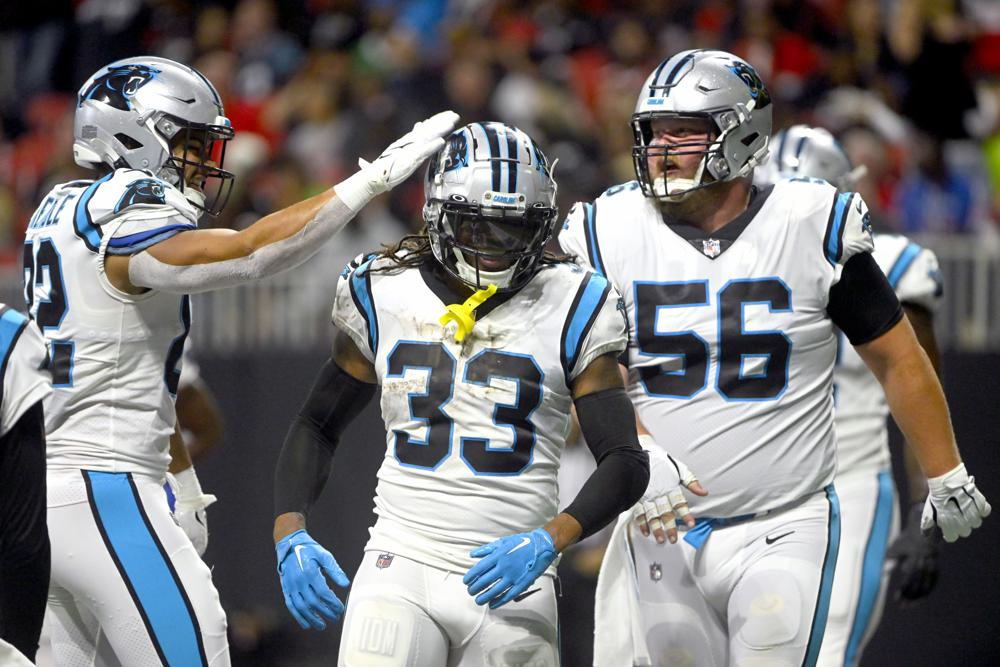 nfl 2022 carolina panthers rb donta foreman 33 congratulated by tommy tremble left and bradley bozeman 56 after scoring against atlanta falcons oct 30 ap photo john amis
