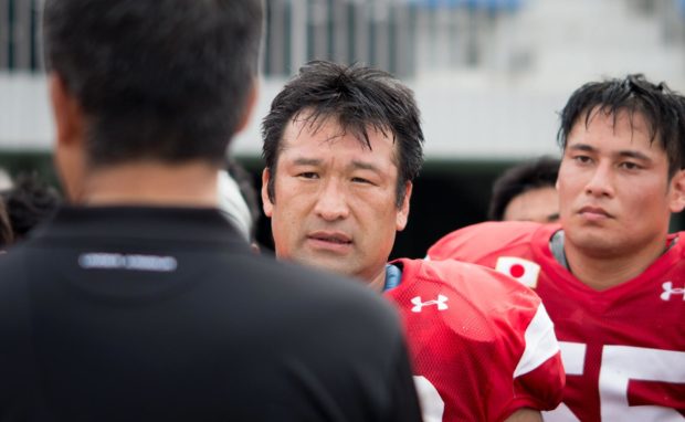 46-year-old defensive lineman Yasuo Wakisaka (center) listens to Head Coach Kiyoyuki on June 14th. A day later Wakisaka was chosen for his record fifth straight World Championship.