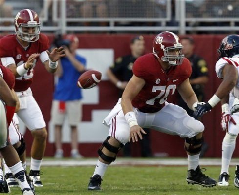Alabama offensive linesman Ryan Kelly (70) blocks out after snapping the ball to quarterback A.J. McCarron (10) during the first half of an NCAA college football game against Mississippi on Saturday, Sept. 28, 2013, in Tuscaloosa, Ala. (AP Photo/Butch Dill)