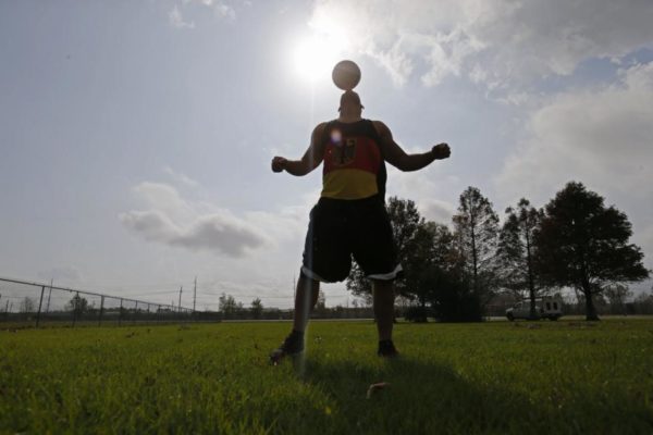 FILE - In this Dec. 16, 2015, file photo, New Orleans Saints outside linebacker Kasim Edebali plays with a soccer ball in Metairie, La. Edebali parlayed his American high school experience into a scholarship at Boston College, then signed with New Orleans as an undrafted free agent in 2014. (AP Photo/Gerald Herbert, File)