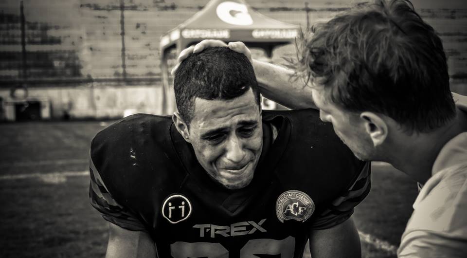An emotional Well Garcia shares a moment with Timbo Head Coach, Amadeu Salvador, after winning the Superliga national title. Garcia rushed for three touchdowns in the game. Photo credit: Jayson Braga