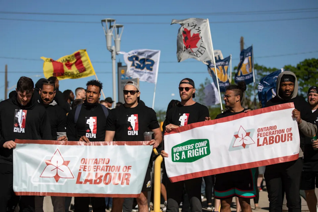 CFL-2022-CFL-Players-Association-CFLPA-members-and-local-labor-union-representatives-demonstrate-outside-Tim-Hortons-Field-May-17-2022.-Nick-Iwanyshyn-The-Canadian-Press-via-AP-1024x683.png